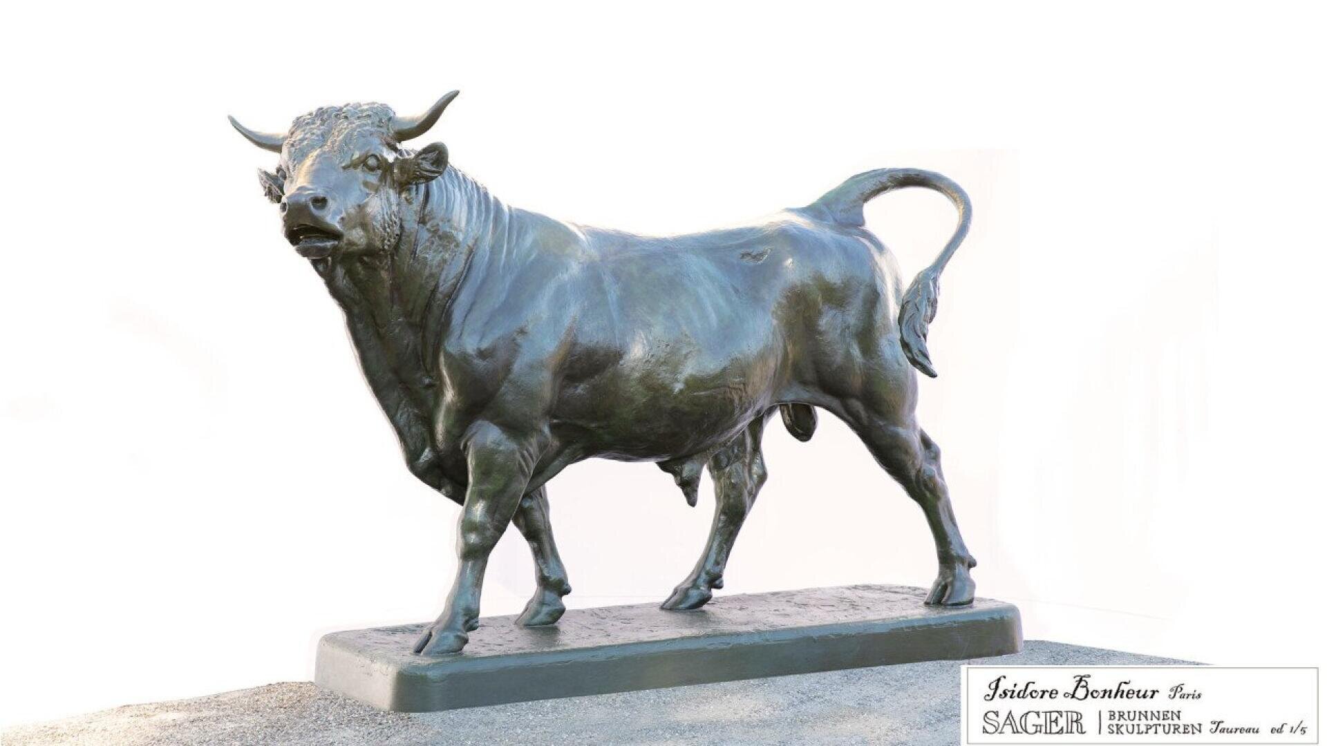 A bronze statue of a strong, muscular bull stands on a rectangular base. The bull has its head slightly turned and its tail curved upwards. The background is white with a plaque in the lower right corner.
