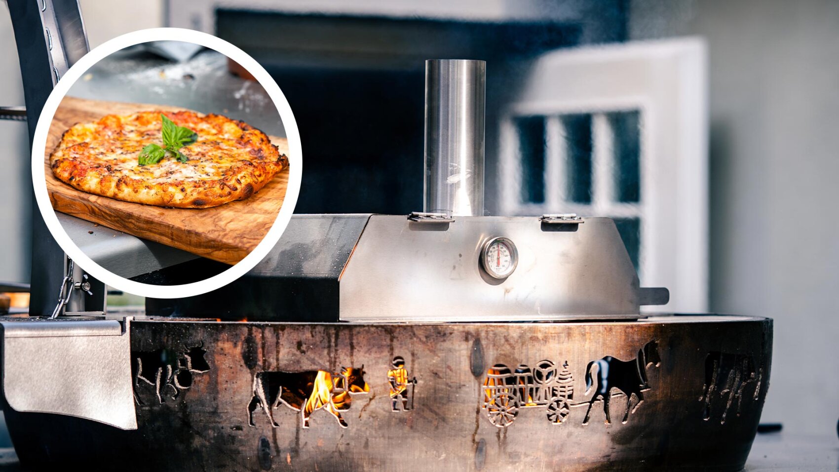 A wood-fired outdoor pizza oven with metal cladding and horse-drawn carriage motifs, illustrated with a circular insert of a baked pizza on a wooden board, topped with fresh basil.
